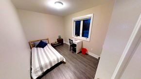 Ottawa apartment for rent - a small bedroom with a bed and a window