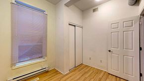 Ottawa apartment for rent - a bedroom with a window and a door and wood floors
