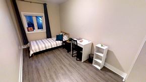 Ottawa apartment for rent - a small room with a desk and a bed