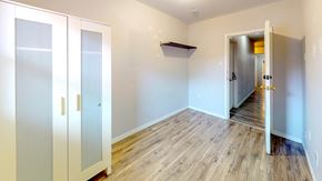 Ottawa apartment for rent - an empty room with wood flooring and white walls and doors