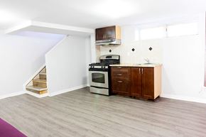 Ottawa apartment for rent - an empty kitchen with a stove and a sink
