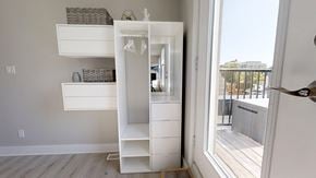 Ottawa apartment for rent - a small white closet in a room with a door to a balcony
