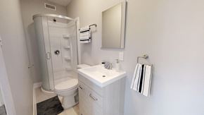 Ottawa apartment for rent - a white bathroom with a shower sink and toilet
