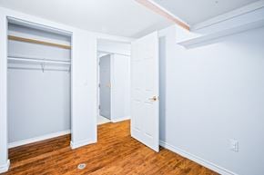 Ottawa apartment for rent - a bedroom with wood floors and blue walls and a closet