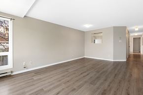 Ottawa condo for rent - the living room and dining room of an empty house with wood flooring