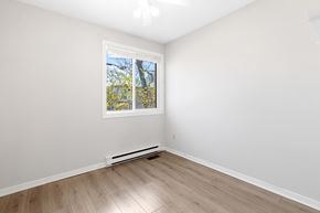 Ottawa condo for rent - an empty room with white walls and a window