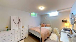 Ottawa apartment for rent - a bedroom with a bed and a dresser