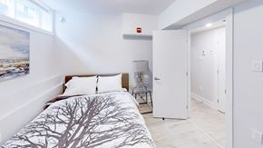 Ottawa apartment for rent - a bedroom with a bed and a door to a bathroom