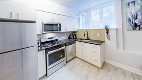 Ottawa apartment for rent - a modern kitchen with stainless steel appliances and white cabinets