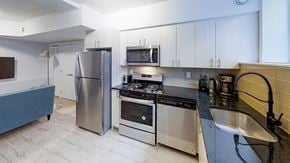Ottawa apartment for rent - a kitchen with stainless steel appliances and white cabinets