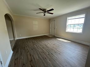 Atlanta apartment for rent - an empty living room with wooden floors and a ceiling fan