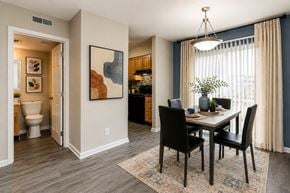 Nashville apartment for rent - A dining room with a table set for two and a painting on the wall.