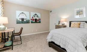 Nashville apartment for rent - a bedroom with a bed and two paintings on the wall