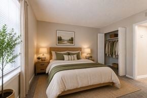 Nashville apartment for rent - A bedroom with a large bed and a painting on the wall.