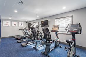 Nashville apartment for rent - A gym with a row of stationary bikes and a television mounted on the wall.