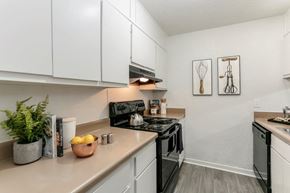 Nashville apartment for rent - A kitchen with a black stove top oven and white cabinets.