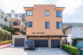Oakland apartment for rent - A two-story house with a garage and a car parked in front.