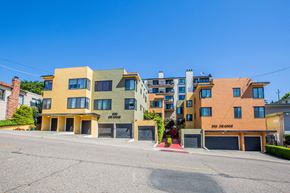 Oakland apartment for rent - A row of modern townhouses with garages and driveways.