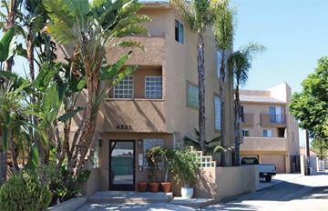 Los Angeles apartment for rent - a building with palm trees in front of it