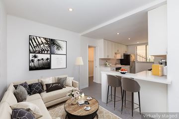 Oakland apartment for rent - A living room with a couch, a coffee table, and a painting on the wall.