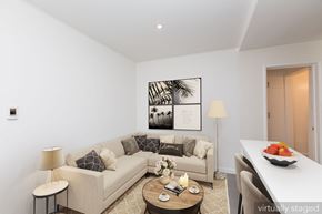 Oakland apartment for rent - A living room with a couch, a coffee table, and a painting on the wall.