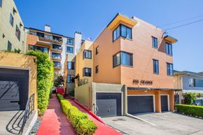 Oakland apartment for rent - A row of houses with a red pathway in the middle.