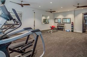 Savannah apartment for rent - the gym has plenty of exercise equipment and a mirror