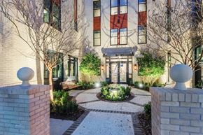 Savannah apartment for rent - a courtyard in front of a building with trees and a fountain