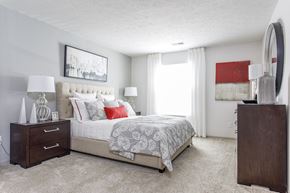 North Royalton apartment for rent - a bedroom with a bed and a dresser and a window