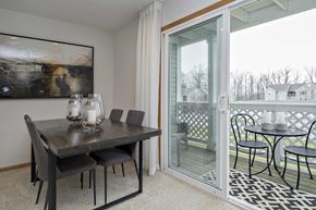 North Royalton apartment for rent - a dining area with a table and chairs and a sliding glass door to a balcony