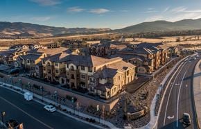 Reno apartment for rent - an aerial view of a neighborhood with cars on the street and buildings
