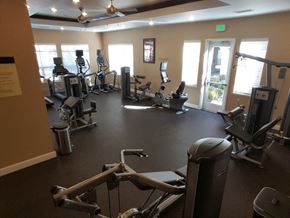 Reno apartment for rent - a gym with cardio equipment and windows in a building