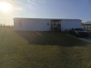 Beech Island house for rent - A white building with a car parked in front of it.