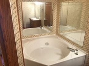 Honea Path house for rent - A bathroom with a white sink and a large mirror.