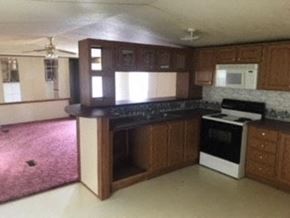 Honea Path house for rent - A kitchen with a black oven and a white microwave.