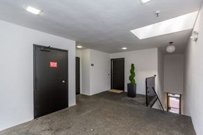 San Francisco apartment for rent - A room with a black door and a grey carpet.