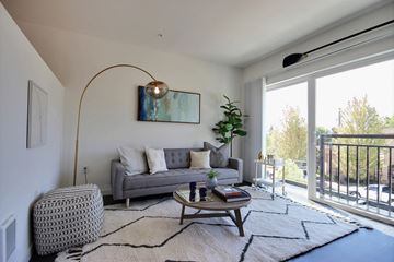 Seattle apartment for rent - a living room with a couch and a table    and a balcony