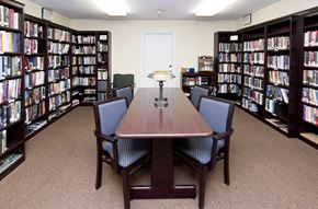 Trumbull apartment for rent - a library with a table and chairs and shelves of books