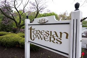 Trumbull apartment for rent - a sign that reads terrisan towers in front of a garden