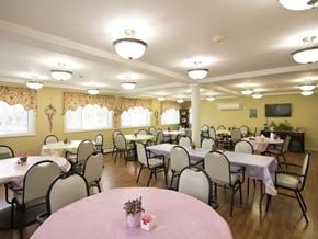 Bethel apartment for rent - a dining room with tables and chairs in a room with yellow walls