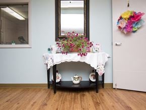 Bethel apartment for rent - a table with a vase and flowers on it next to a mirror