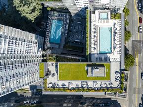 Seattle apartment for rent - A large building with a pool in the middle of a grassy area.