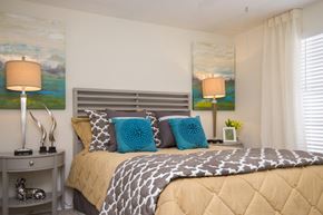 North Royalton apartment for rent - a bedroom with a bed and pillows and paintings on the wall