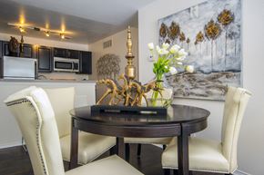 North Royalton apartment for rent - a dining room with white chairs and a table with flowers