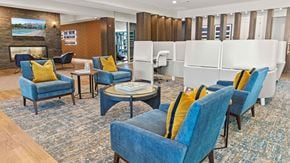 York apartment for rent - a lounge area with blue chairs and a fireplace