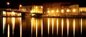 Campbellford apartment for rent - a city at night with its lights reflected in the water