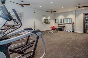 Savannah apartment for rent - the gym has plenty of exercise equipment and a mirror