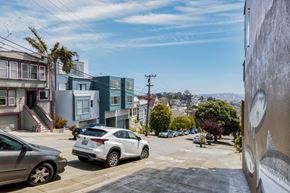 San Francisco apartment for rent - A street view with cars and buildings.