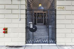 San Francisco apartment for rent - A black gate with a round sign on it that says 1950.