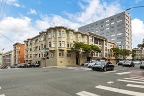 San Francisco apartment for rent - A street view of a city with cars and buildings.